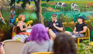 Parents and professionals discussing the benefits of family therapy in a supportive group setting