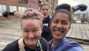 A group of 3 individuals smiling for a photo with someone in the background wearing boxing gloves. Representing close friendship & bonds. Discover how a women's therapist in Lynn, MA can help you with setting boundaries.